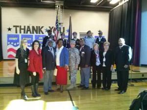 Washington Rose staff stand with visiting veterans 